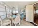 Bright sunroom with glass table, wicker chairs, and a comfy sofa at 18675 Us Highway 19 N # 232, Clearwater, FL 33764