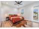 Spacious bedroom with king-size bed, hardwood floors, and private balcony access at 1910 W Union St, Tampa, FL 33607