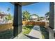 View from the front porch, showcasing a well-maintained lawn and wooden fence at 1910 W Union St, Tampa, FL 33607