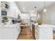 Modern kitchen with white cabinets, quartz countertops, and gold hardware at 1910 W Union St, Tampa, FL 33607