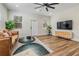 Bright living room with a leather couch, coffee table, and large TV at 1910 W Union St, Tampa, FL 33607