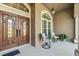 Inviting front porch with double doors and seating at 2048 Edelweiss Loop, Trinity, FL 34655