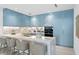 Modern kitchen with blue cabinetry, marble countertops, and gold fixtures at 3020 W Santiago St # 5, Tampa, FL 33629