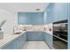 Modern kitchen with blue cabinets and marble countertops at 3020 W Santiago St # 5, Tampa, FL 33629
