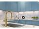Modern kitchen with a gold faucet and blue cabinetry at 3020 W Santiago St # 5, Tampa, FL 33629