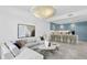 Open concept living room with sectional sofa and view into the kitchen at 3020 W Santiago St # 5, Tampa, FL 33629