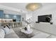 Open living space with a sectional sofa, kitchen, and large TV at 3020 W Santiago St # 5, Tampa, FL 33629