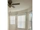 Spacious bedroom with ceiling fan and vertical blinds at 4015 Woodacre Ln, Tampa, FL 33624