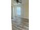 Spacious bedroom with wood-look vinyl flooring and window at 4015 Woodacre Ln, Tampa, FL 33624
