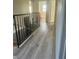 Upstairs hallway with new flooring and metal railing at 4015 Woodacre Ln, Tampa, FL 33624