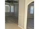 Open living room with wood-look floors and arched doorways at 4015 Woodacre Ln, Tampa, FL 33624