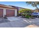Charming home featuring a well-maintained front yard with colorful foliage and a private garage at 4542 Park Lake N Ter # 4542, Bradenton, FL 34209