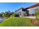 Back exterior showing the screened-in sunroom and grassy backyard at 4542 Park Lake N Ter # 4542, Bradenton, FL 34209
