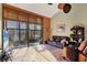 Living room with sliding glass doors, leather couches, and a view of the patio at 4542 Park Lake N Ter # 4542, Bradenton, FL 34209