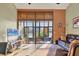 Spacious living room with sliding glass doors leading to a patio, and a leather couch at 4542 Park Lake N Ter # 4542, Bradenton, FL 34209