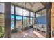 Bright sunroom with lake view, wicker furniture, and tiled floor at 4542 Park Lake N Ter # 4542, Bradenton, FL 34209