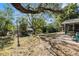 Large backyard with patio, fire pit, and mature trees at 6050 Waycross Dr, Spring Hill, FL 34606