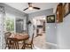 Bright dining area with wood table and chairs, view of kitchen at 6050 Waycross Dr, Spring Hill, FL 34606