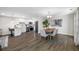 Dining room with a wooden table and chairs, adjacent to a modern kitchen at 695 Sandy Hook Rd, Palm Harbor, FL 34683