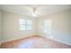 Bedroom with laminate wood floors and two windows at 702 W Cherry St, Plant City, FL 33563