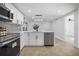 Modern kitchen with white cabinets, stainless steel appliances, and island at 7431 Daggett Ter, New Port Richey, FL 34655