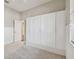 Bedroom with grey carpet, large white closet and window at 8831 Garden Party Dr, Land O Lakes, FL 34637