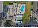 Aerial view showing community pool, shuffleboard courts, and parking at 9815 47Th N Ave # 202, St Petersburg, FL 33708