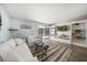 Relaxing living room with comfy sofas, built-in shelving, and sliding door access to patio at 12352 Monarch Cir, Seminole, FL 33772