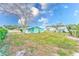 Backyard view of a light green house with a large grassy area at 1313 Michigan Ave, Palm Harbor, FL 34683