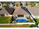 Aerial view of house, showcasing backyard pool and landscaping at 13423 White Sapphire Rd, Riverview, FL 33579