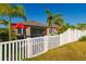 Private backyard with a white fence and gate at 13423 White Sapphire Rd, Riverview, FL 33579