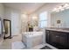 Luxurious bathroom with a soaking tub and double vanity at 13423 White Sapphire Rd, Riverview, FL 33579