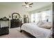 Spacious bedroom with king-size bed, dresser, and treadmill at 13423 White Sapphire Rd, Riverview, FL 33579
