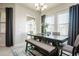 Bright dining room features a dark wood table with bench seating and large windows at 13423 White Sapphire Rd, Riverview, FL 33579