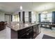 Large kitchen island with granite countertop and seating for four at 13423 White Sapphire Rd, Riverview, FL 33579