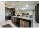 Modern kitchen with dark cabinetry, granite countertops, and stainless steel appliances at 13423 White Sapphire Rd, Riverview, FL 33579