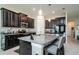 Modern kitchen with island, granite countertops, and stainless steel appliances at 13423 White Sapphire Rd, Riverview, FL 33579