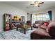 Spacious living room with brown leather sectional sofa and large TV at 13423 White Sapphire Rd, Riverview, FL 33579