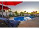 Inviting kidney-shaped pool with lounge chairs and string lights at 13423 White Sapphire Rd, Riverview, FL 33579