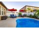 Inviting pool area with lounge chairs and red umbrellas at 13423 White Sapphire Rd, Riverview, FL 33579