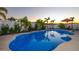 Relaxing kidney-shaped pool, surrounded by lush landscaping at 13423 White Sapphire Rd, Riverview, FL 33579