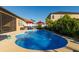 Inviting kidney-shaped pool with red umbrellas and lush landscaping at 13423 White Sapphire Rd, Riverview, FL 33579