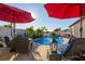 Stunning pool area with patio furniture and red umbrellas at 13423 White Sapphire Rd, Riverview, FL 33579