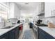 Modern kitchen with white and blue cabinets and stainless steel appliances at 1600 Beach Trl, Indian Rocks Beach, FL 33785