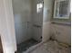 Bathroom with a glass shower enclosure and tiled walls at 16333 Gulf Blvd # 118, St Petersburg, FL 33708