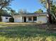 Ranch-style home with attached garage and mature landscaping at 1711 Michigan Ne Ave, St Petersburg, FL 33703
