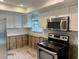 Modern kitchen under renovation, new stove and microwave at 1711 Michigan Ne Ave, St Petersburg, FL 33703