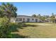 Backyard view of home, featuring a grassy area at 17163 2Nd E St, North Redington Beach, FL 33708