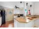 Kitchen with breakfast bar, white cabinets, and a door leading to the backyard at 1840 42Nd N Ave, St Petersburg, FL 33714