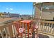 Small balcony with ocean views, featuring two pink metal chairs and a small table at 19810 Gulf Blvd # 8, Indian Shores, FL 33785